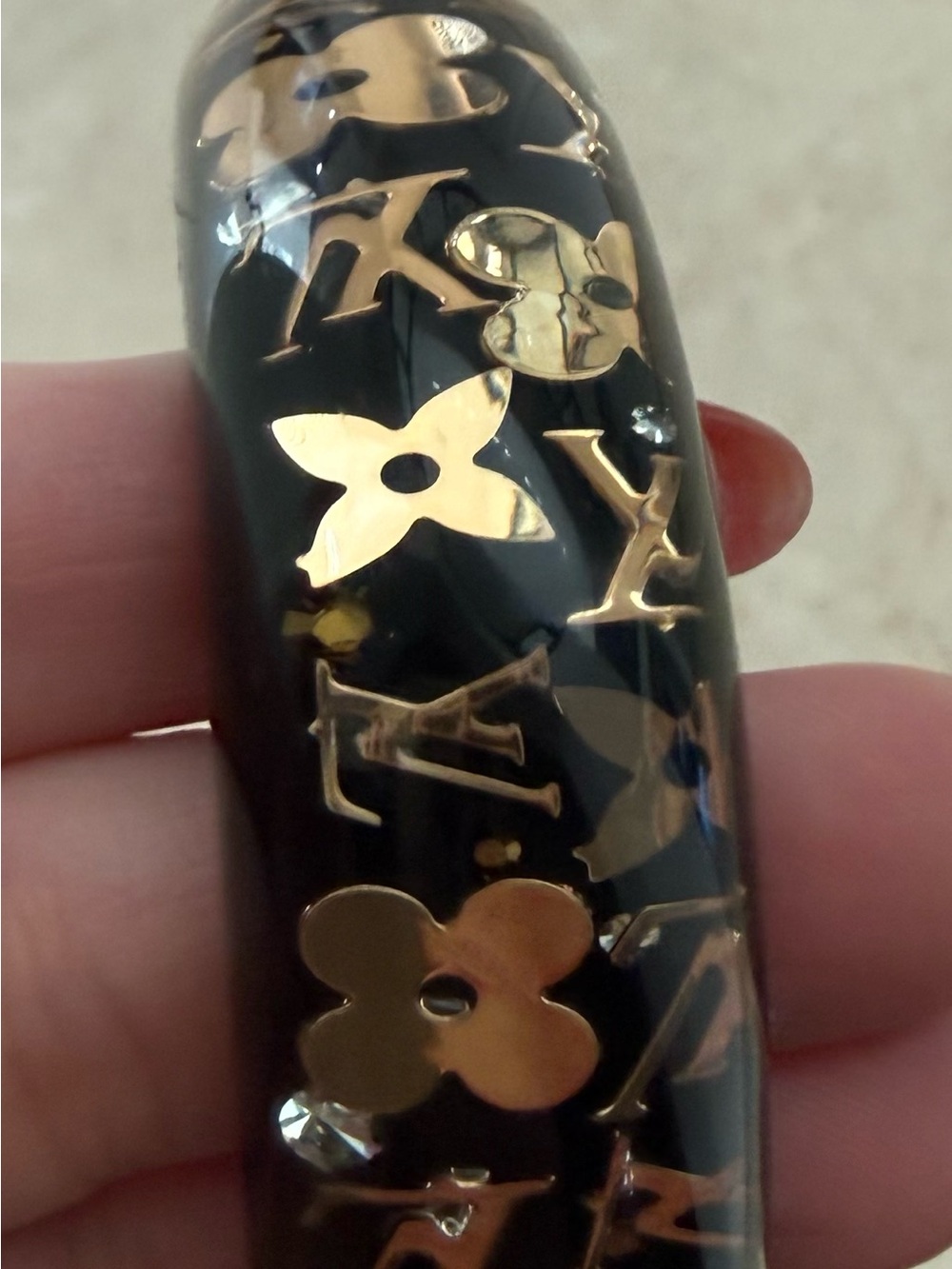 Louis Vuitton Black Bangle with Gold Monogram Detail